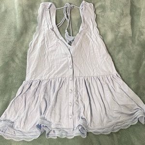 Light blue flows tank top.With strings that tie in back and buttons on the front